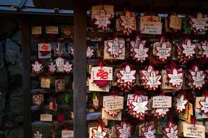 Kurama, Kyoto Prefecture, Kansai, Japan - November 21, 2019 - Small wooden plaques, or Ema, for write some wishes in Kifune Jinja, or Kifune Shrine photo