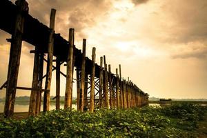 U Bein Bridge, the oldest and longest teakwood bridge in the world that crossing the Taungthaman lake near Amarapura, Myanmar photo