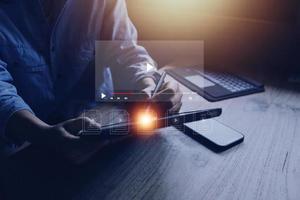 man using mouse and keyboard for streaming online, watching video on internet, live concert, show or tutorial photo