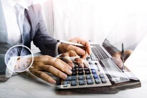 Woman entrepreneur using a calculator with a pen in her hand, calculating financial expense at home office photo