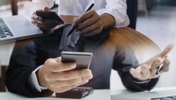 Business partnership coworkers using a tablet to analysis graph company financial budget report and cost work progress and planning for future in office room. photo