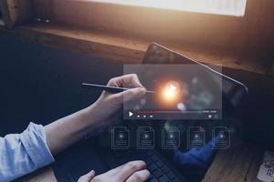 man using mouse and keyboard for streaming online, watching video on internet, live concert, show or tutorial photo