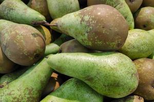 Stack of pears on a market stall photo