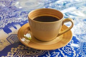 Glass Cup of black coffee in a restaurant Phuket Thailand. photo