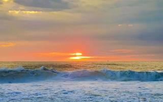 Colorful golden sunset big wave and beach Puerto Escondido Mexico. photo