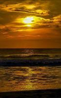 Colorful golden sunset big wave and beach Puerto Escondido Mexico. photo