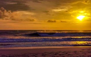 Colorful golden sunset big wave and beach Puerto Escondido Mexico. photo