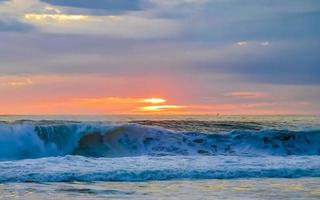 Colorful golden sunset big wave and beach Puerto Escondido Mexico. photo