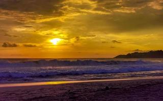 Colorful golden sunset big wave and beach Puerto Escondido Mexico. photo