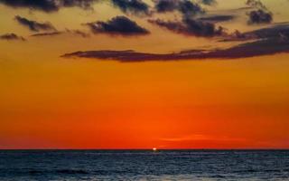 Colorful golden sunset big wave and beach Puerto Escondido Mexico. photo