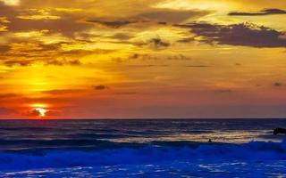 Colorful golden sunset big wave and beach Puerto Escondido Mexico. photo