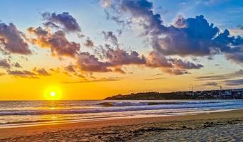 Colorful golden sunset big wave and beach Puerto Escondido Mexico. photo