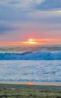 Colorful golden sunset big wave and beach Puerto Escondido Mexico. photo