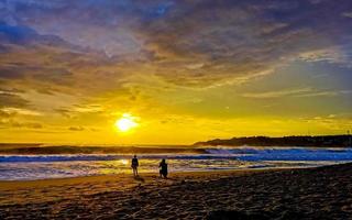 Colorful golden sunset big wave and beach Puerto Escondido Mexico. photo