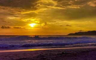 Colorful golden sunset big wave and beach Puerto Escondido Mexico. photo