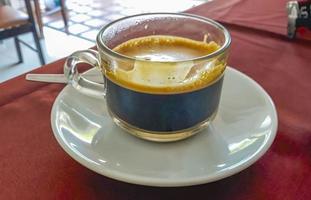 Glass Cup of black coffee in a restaurant Phuket Thailand. photo