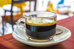 Glass Cup of black coffee in a restaurant Phuket Thailand. photo