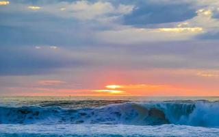 Colorful golden sunset big wave and beach Puerto Escondido Mexico. photo