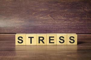 stress word on wooden blocks and wooden background photo