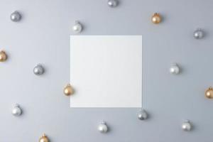 Christmas grey minimal background with mock up greetings card and ball. Flat lay, copy space photo