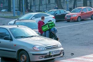 Dnepropetrovsk, Ukraine - 11.22.2021 Accident of two passenger cars due to wrong actions of a food delivery man on a moped. photo