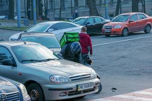 Dnepropetrovsk, Ukraine - 11.22.2021 Accident of two passenger cars due to wrong actions of a food delivery man on a moped. photo