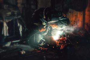 worker welder making a seam butt joint on a pipe photo