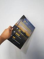 West Java in August 2022. A hand holds the Indonesian version of the National Geographic magazine. photo