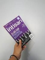 West Java, August 2022. A hand is holding an Intisari magazines December 2021 edition with the theme Traces of the Archipelago Evangelist photo