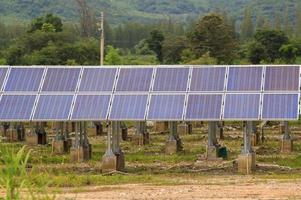 Solar panels located in the foothills to generate electricity, clean, environmentally friendly energy in industrial systems to be sold and sold to those who want to buy on a hot sunny day. photo