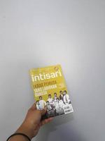 West Java, August 2022. A hand is holding an Intisari magazines. October 2021 edition with the theme Pledge of Youth Born by the Nation. photo