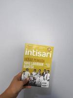 West Java, August 2022. A hand is holding an Intisari magazines. October 2021 edition with the theme Pledge of Youth Born by the Nation. photo