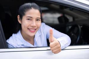 The saleswoman holds the new car keys. Ready to deliver to customers at the showroom. photo