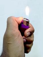 Hand of young boy holding a lighter photo