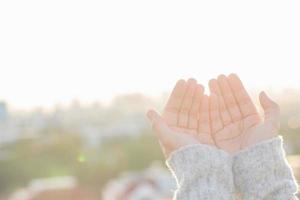 Women raise their hands to ask for blessing from God. photo