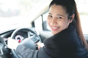 Salesman is carrying the car keys delivered to the customer at the showroom with a low interest offer. Special promotion photo