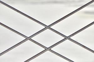 Metal fence with rhombus ornament on grey background photo