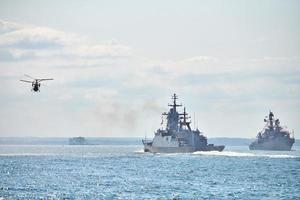 Battleships war ships corvette during naval exercises and helicopter maneuvering over sea, warships photo