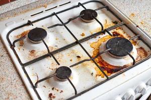 Dirty stove with food leftovers photo