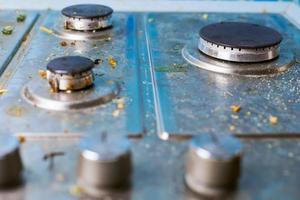 Dirty gas stove with food leftovers and crumbs photo