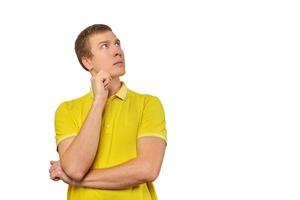 Thoughtful man in yellow T-shirt looking to right, white background, philosophical reflection photo