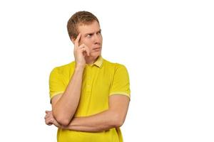 Thoughtful man in yellow T-shirt looking to right, white background, philosophical reflection photo