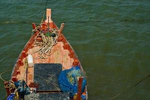 Wooden fishing boat coastal drift after returning from fishing photo