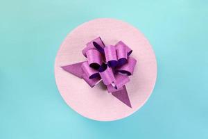 Round gift box with bow, top view photo