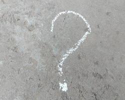 question mark is drawn in chalk on the pavement. problem concept. photo