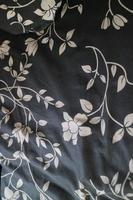 black cloth with pictures of plants and flowers photo