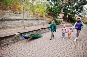 Mother with kids walking peacock at zoo. photo