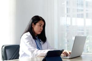 close up - A female nurse in a white uniform talks online with a sick person. medical concept photo