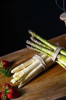 Green and white asparagus on the table photo