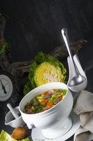 delicious savoy cabbage soup in white vase photo